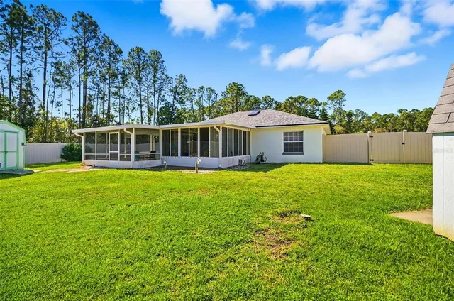 a view of a house with a backyard
