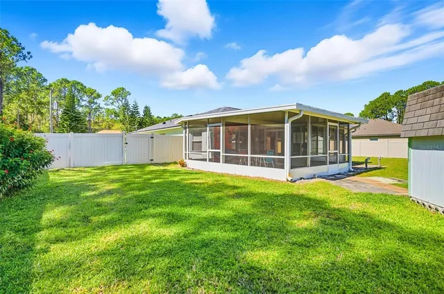 a view of an house with backyard space and balcony