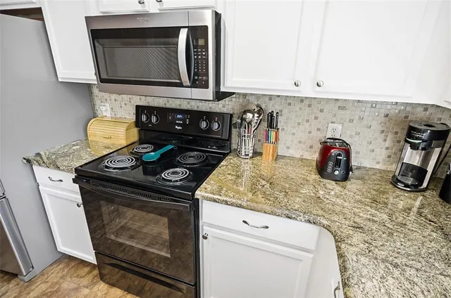 a kitchen with a stove and a microwave