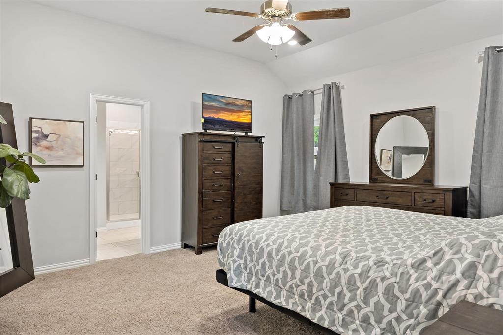 2003 Atlantic Avenue Anna, TX 75409 - Photo 18 of 22 a bedroom with a bed and a chandelier