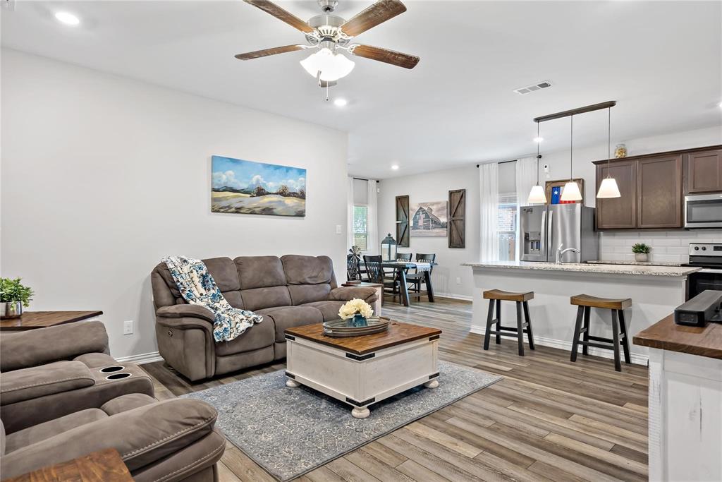 a living room with furniture and kitchen view