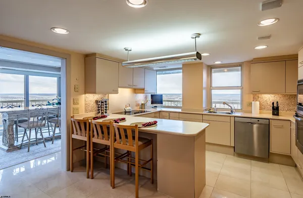 a kitchen with a table chairs sink and cabinets