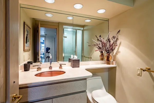 a bathroom with a sink toilet mirror and shower