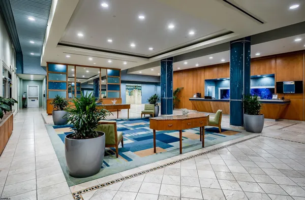 a lobby with furniture and a potted plant