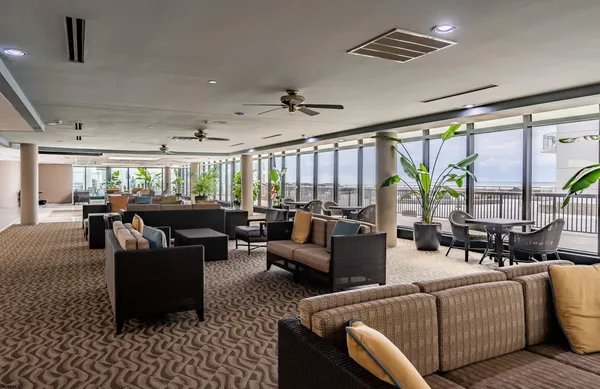 a living room with furniture and floor to ceiling window