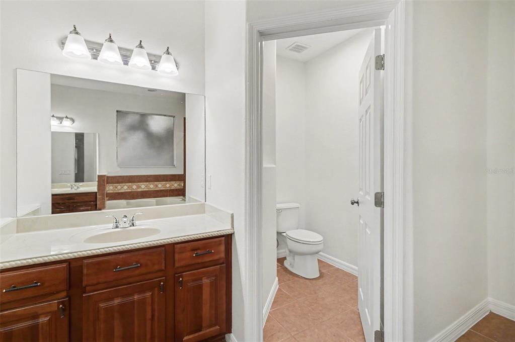 4819 Indian Deer Road Windermere, FL 34786 - Photo 26 of 30 a bathroom with a sink a toilet and a mirror