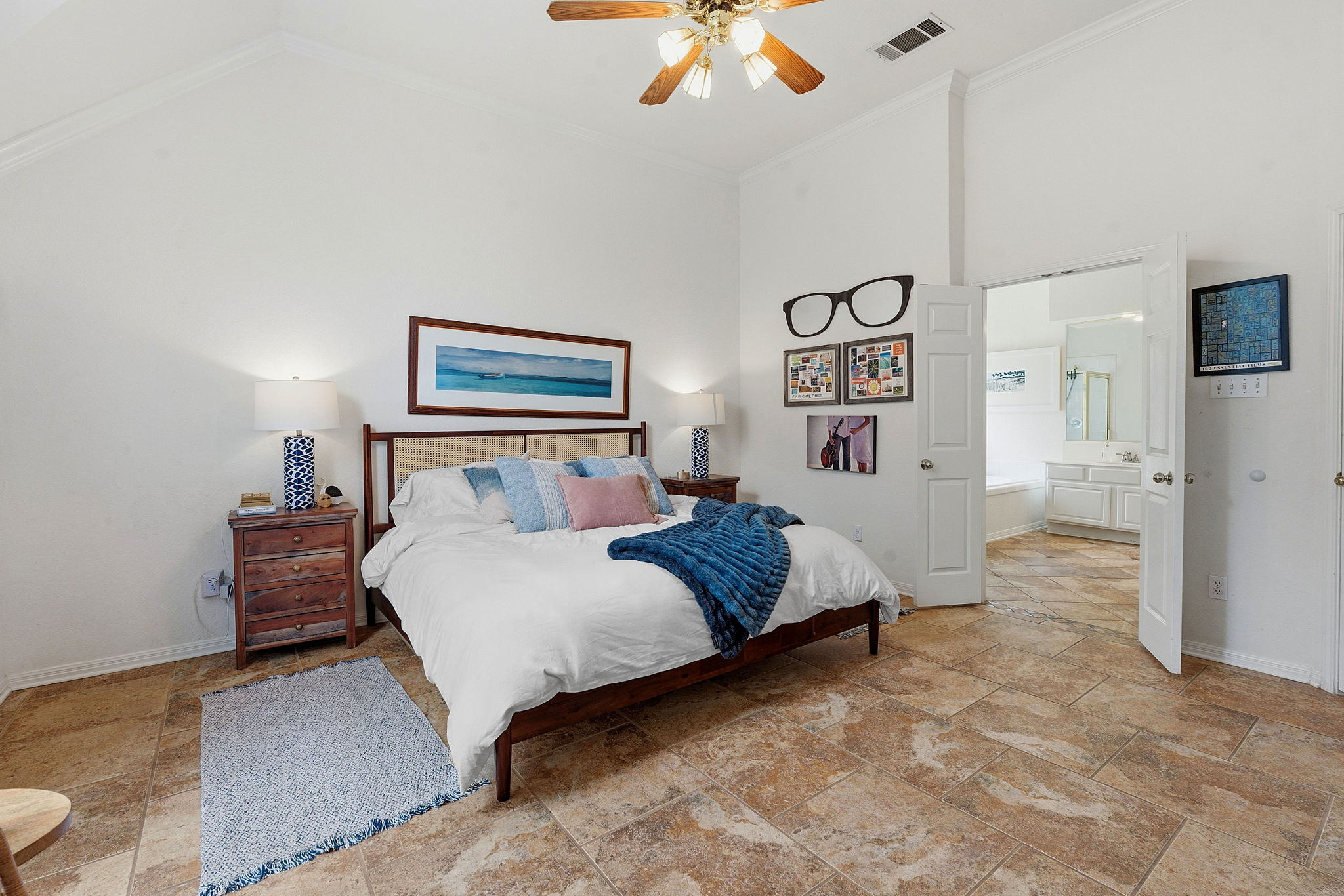 8317 Pommel Drive Austin, TX 78759 - Photo 12 of 26 Relax in this inviting primary bedroom featuring vaulted ceilings and natural tile flooring.