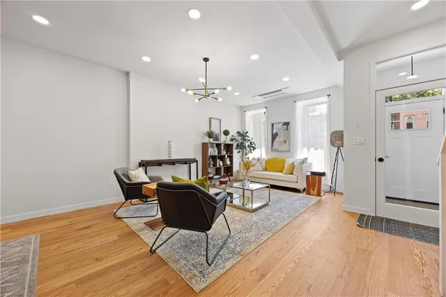 a living room with furniture and a chandelier