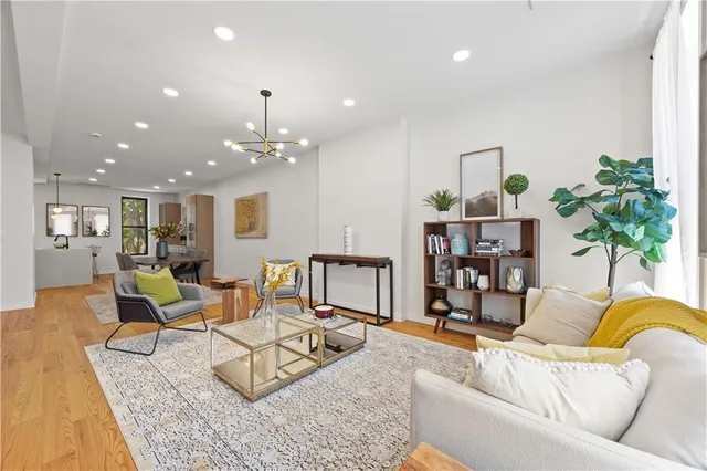 a living room with furniture and a chandelier