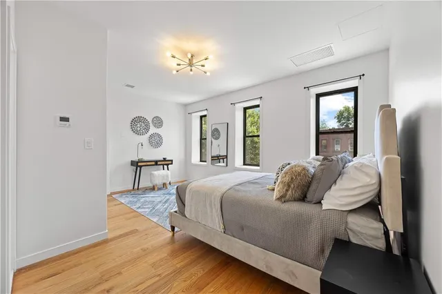 a bedroom with a bed and a chandelier