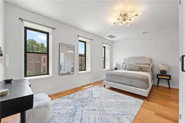 a bedroom with a large bed and a chandelier