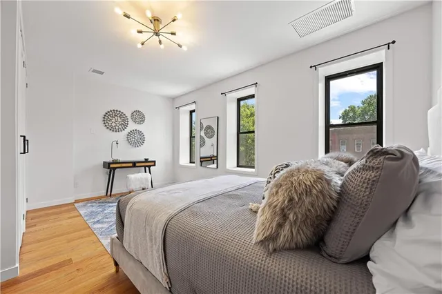 a bed sitting in a bedroom next to a window