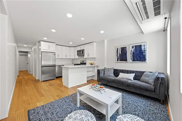 a living room with furniture kitchen and a table