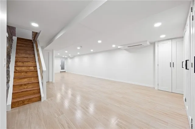 a view of hallway with stairs and wooden floor