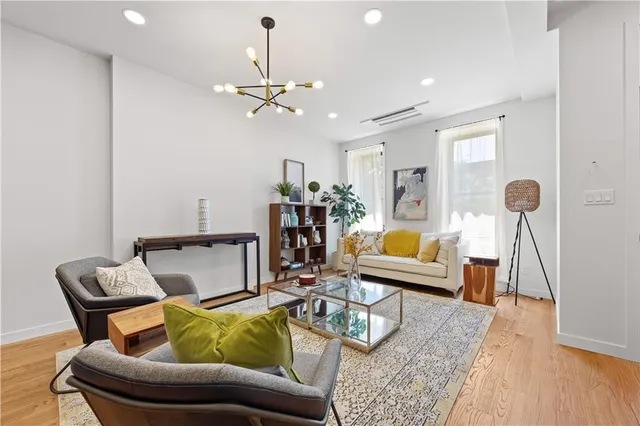 a living room with furniture and wooden floor