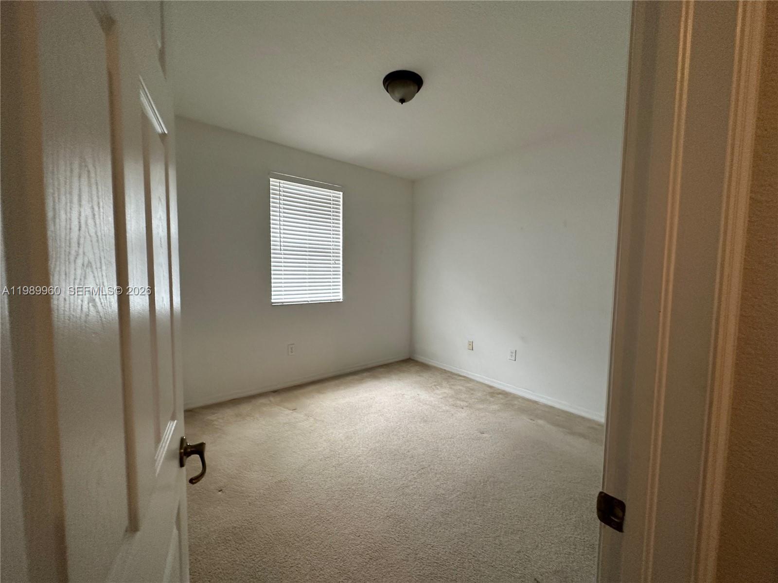16602 Southwest 78th Terrace Miami, FL 33193 - Photo 12 of 18 a view of an empty room with a window