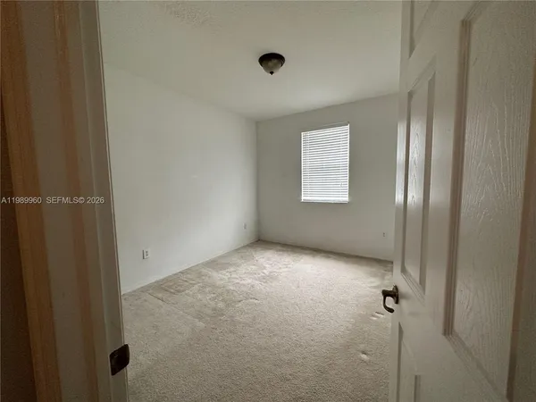 a bathroom with a sink mirror vanity and toilet