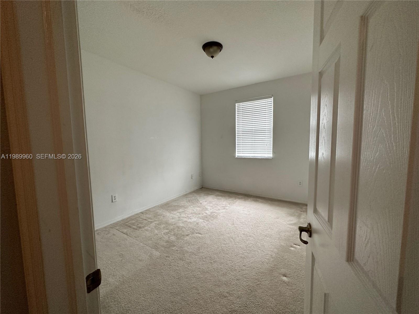 16602 Southwest 78th Terrace Miami, FL 33193 - Photo 13 of 18 a view of an empty room with a window