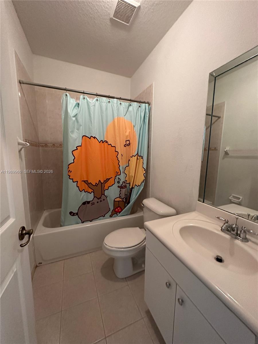 16602 Southwest 78th Terrace Miami, FL 33193 - Photo 14 of 18 a bathroom with a sink mirror vanity and toilet