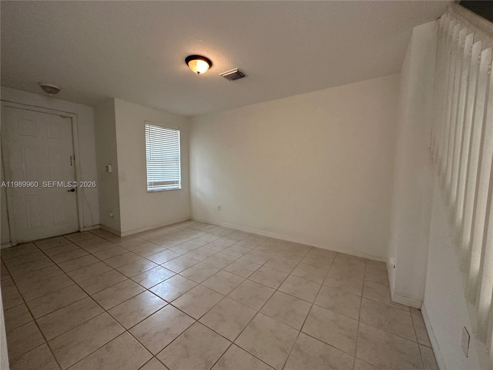 16602 Southwest 78th Terrace Miami, FL 33193 - Photo 5 of 18 an empty room with windows