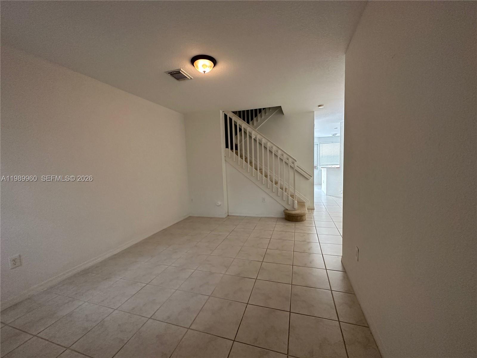 16602 Southwest 78th Terrace Miami, FL 33193 - Photo 6 of 18 a view of an empty room with a window