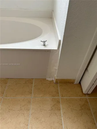 a view of a hallway with wooden floor and entryway