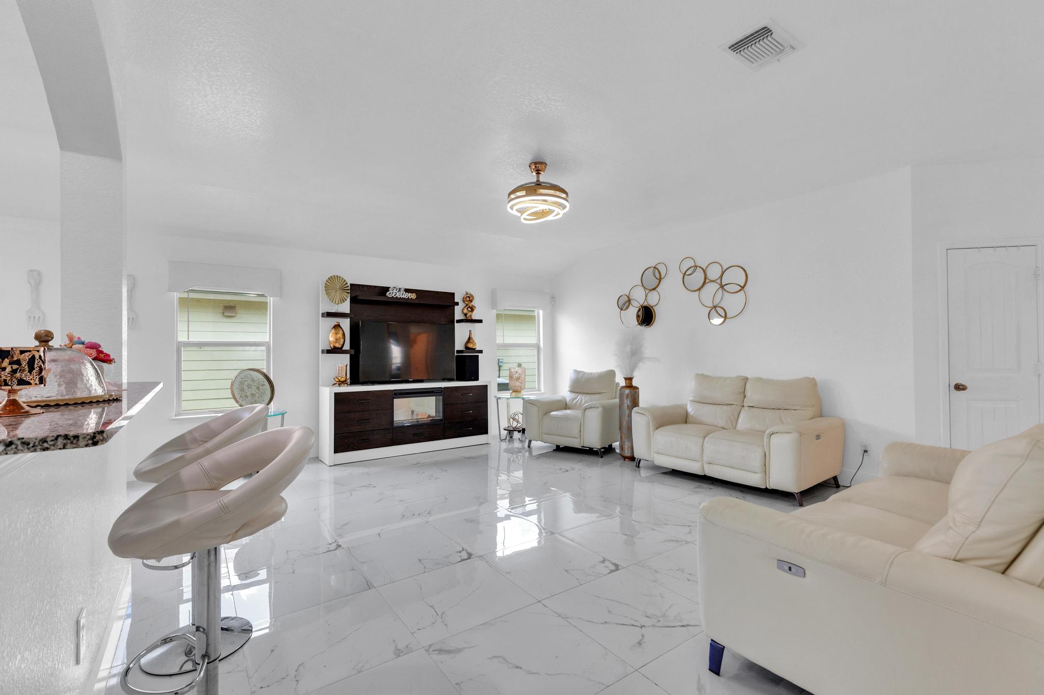 119 Beth Ann Loop Taylor, TX 76574 - Photo 7 of 31 A spacious living room featuring gleaming tile floors and a contemporary entertainment center.