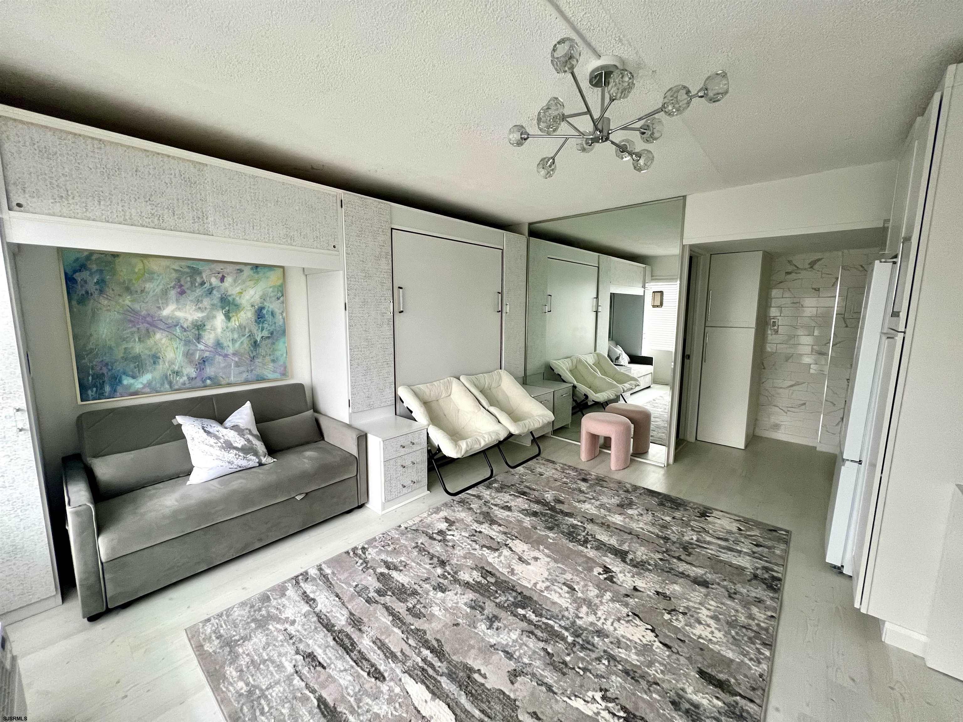 3501 Boardwalk, Unit B206 Atlantic City, NJ 08401 - Photo 2 of 7 a living room with furniture and a large window