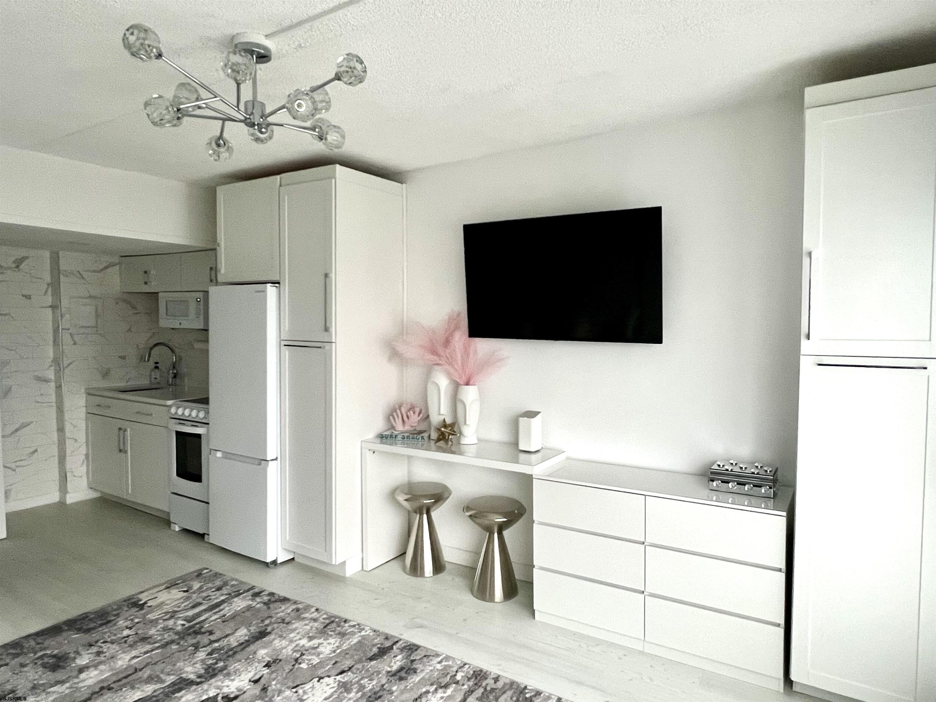 3501 Boardwalk, Unit B206 Atlantic City, NJ 08401 - Photo 3 of 7 a living room with furniture and a flat screen tv