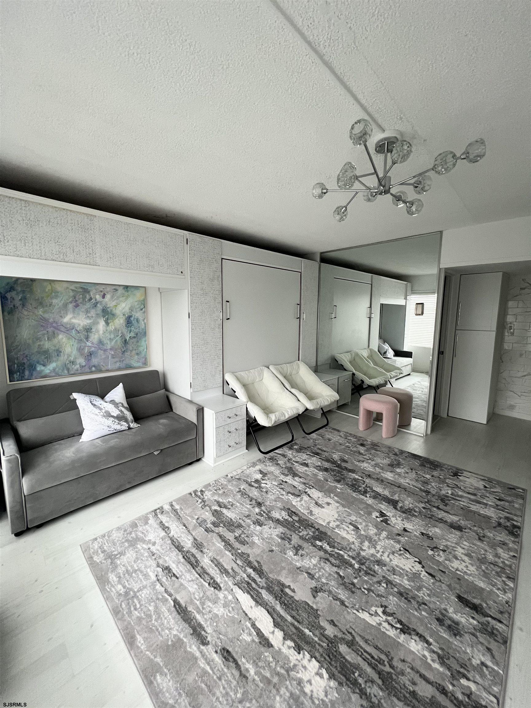 3501 Boardwalk, Unit B206 Atlantic City, NJ 08401 - Photo 4 of 7 a living room with furniture and wooden floor