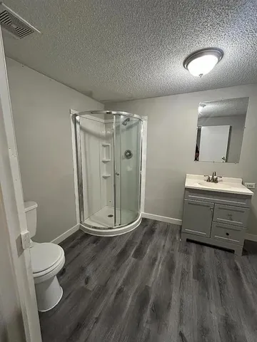 a bathroom with a double vanity sink toilet and shower