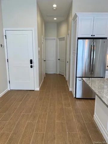 a view of a kitchen with a sink and refrigerator