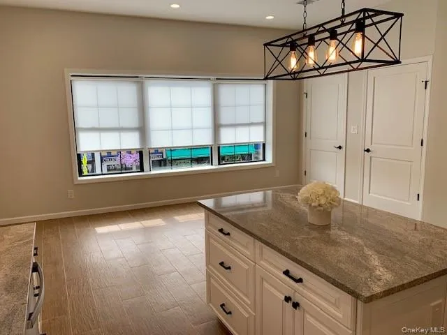 a kitchen with stainless steel appliances granite countertop a sink and a window