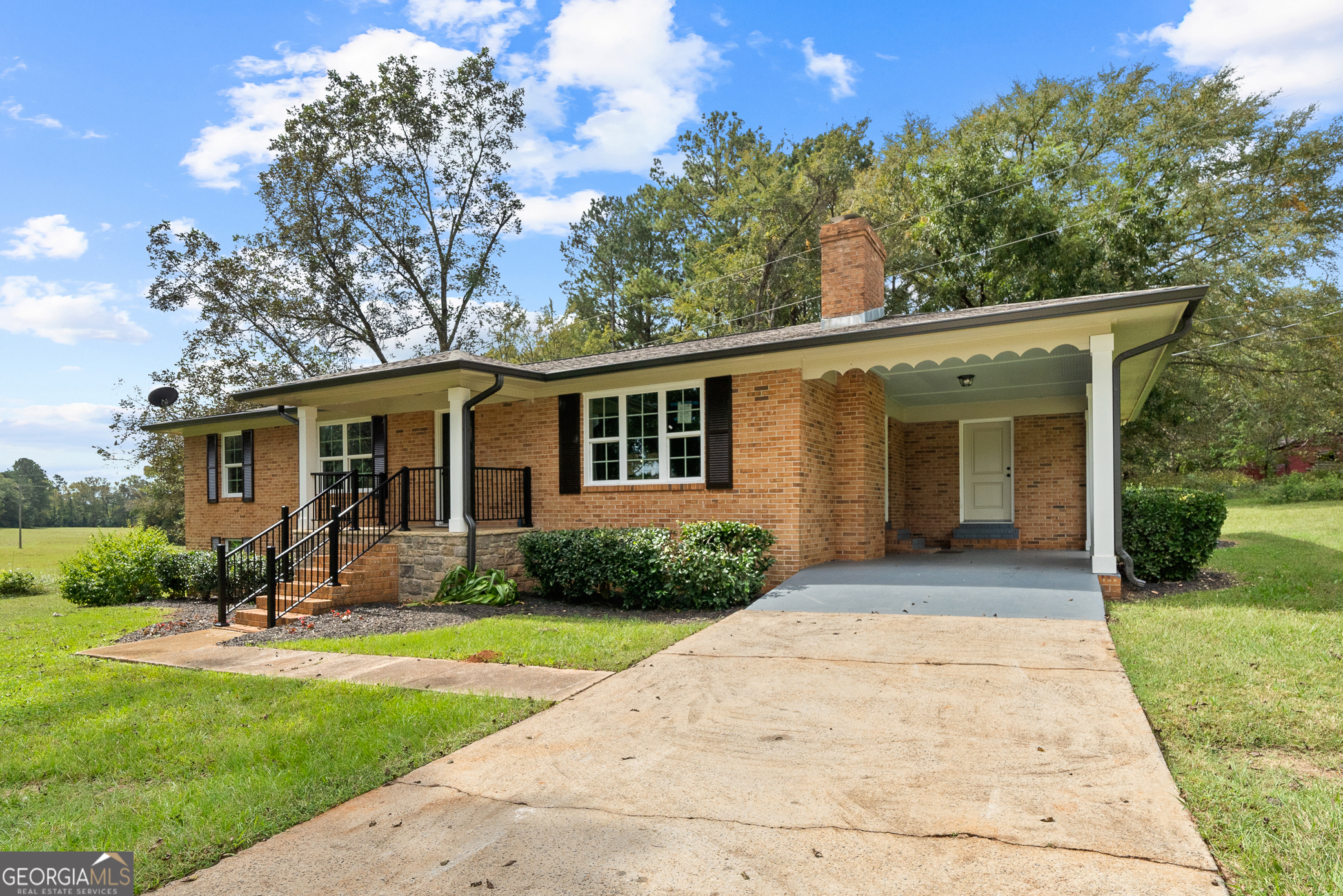 a front view of house with yard and green space