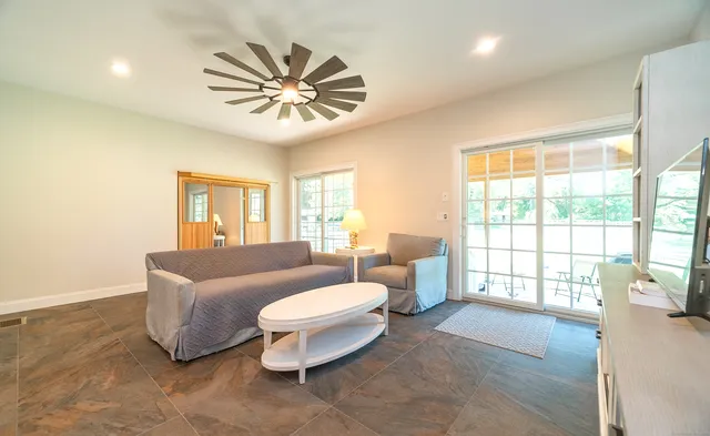 a living room with furniture and a large window
