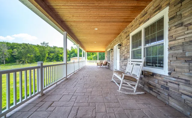 a view of a chairs and table in the balcony