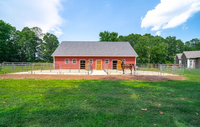 a aerial view of a house with swimming pool and a yard