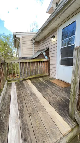 a view of a house with a wooden deck