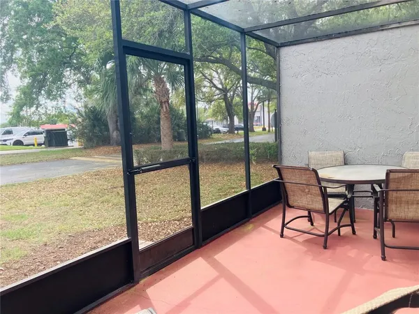 a dining room with furniture and a floor to ceiling window