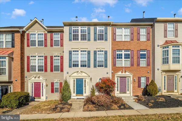 a front view of a residential apartment building with a yard