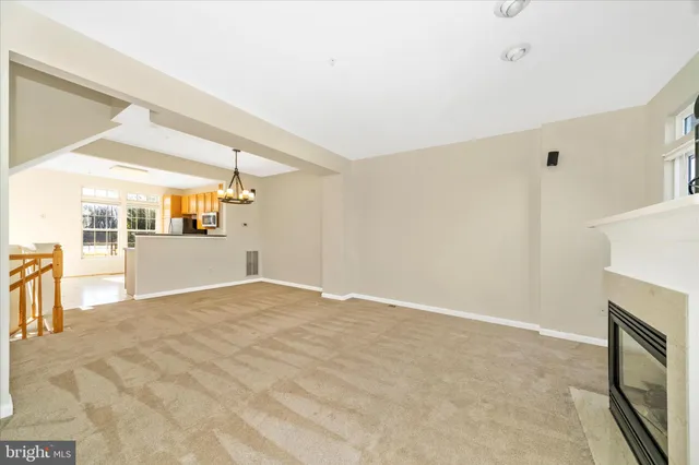 a kitchen with granite countertop a stove a sink and a microwave