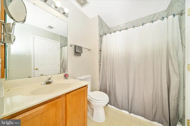 a view of a livingroom with a ceiling fan and window