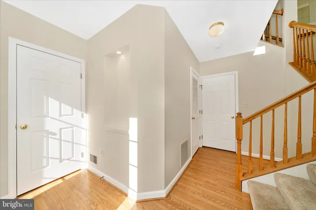 a view of an empty room with a fireplace and a window