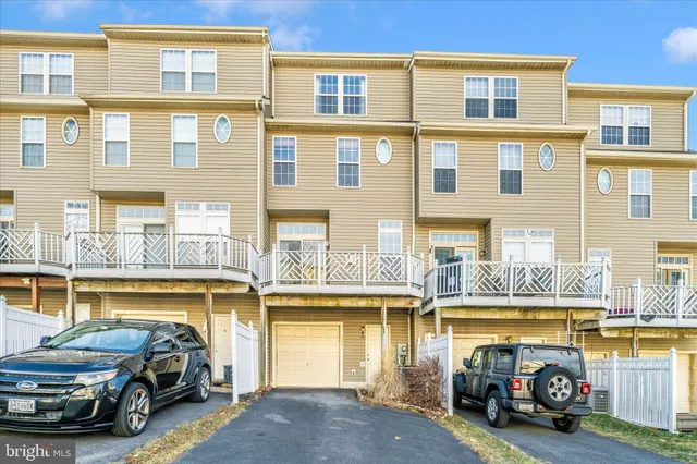 a view of a house with a yard and pathway