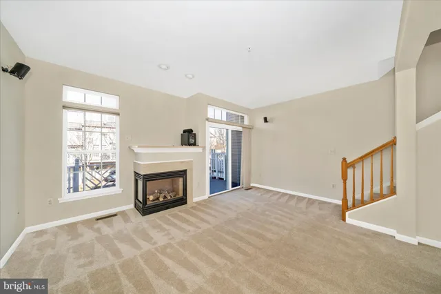 a view of empty room with fireplace and fan