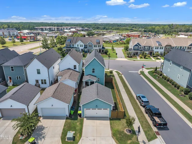 an aerial view of residential houses with outdoor space