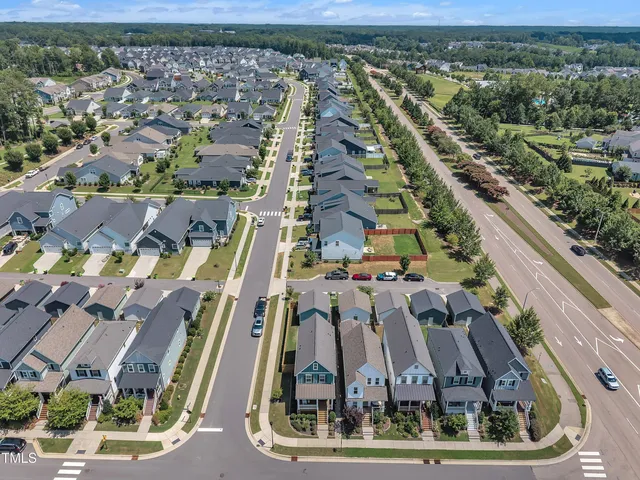 an aerial view of residential houses with outdoor space