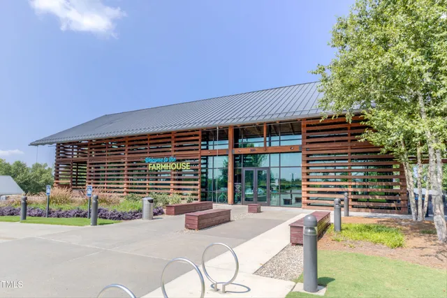 an aerial view of a residential houses with outdoor space and lake view