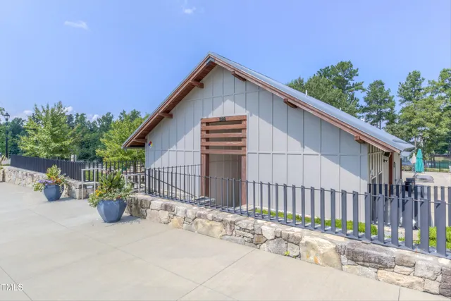 an aerial view of residential houses with outdoor space and lake view