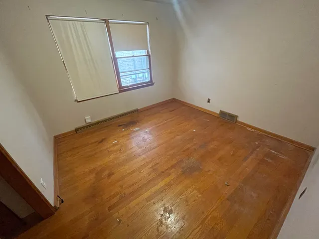 a view of room with window and hardwood floor